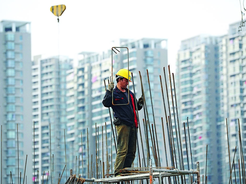 A man works at a construction site in central Beijing, China. — Reuters