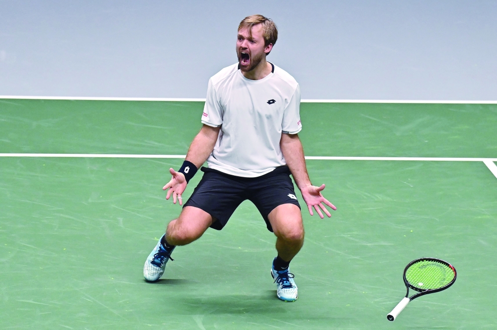 Germany's Kevin Krawietz celebrates as he and Tim Puetz (not in picture) win the men's doubles quarterfinal against Britain at the Davis Cup. -- AFP