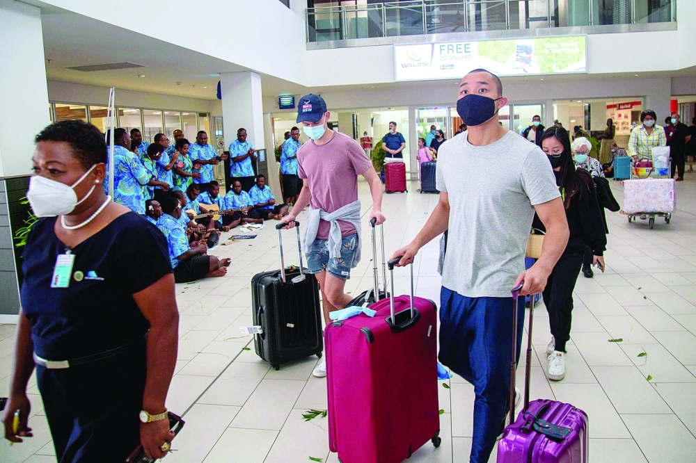 Holidaymakers are greeted by traditional cultural groups in Nadi as Fiji opens its borders to international travellers for the first time since the Covid-19 pandemic.- AFP

