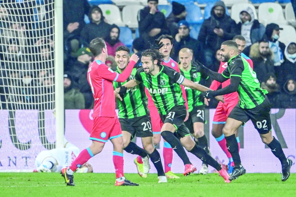 Sassuolo's Gian Marco Ferrari (C) celebrates after scoring an equalizer during the Serie A match against Napoli. -- AFP