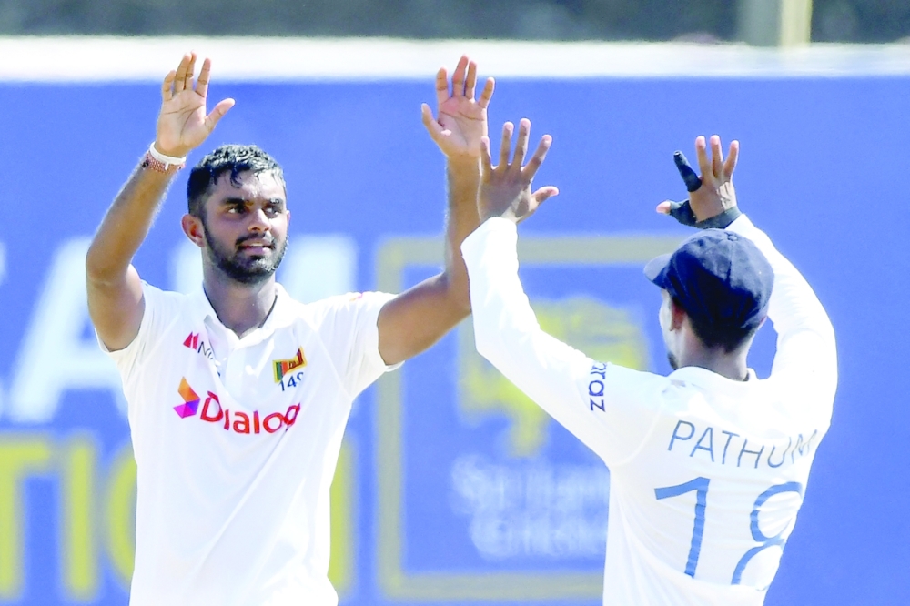 Sri Lanka's Lasith Embuldeniya (L) celebrates with teammate Pathum Nissanka after taking the wicket of West Indies' Jason Holder (not pictured) on the fifth and final day of the second Test. -- AFP