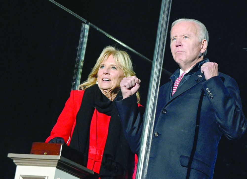 US President Joe Biden and first lady Jill Biden react as they light the 2021 National Christmas Tree during a lighting ceremony on the Ellipse on Thursday in Washington, DC. - AFP