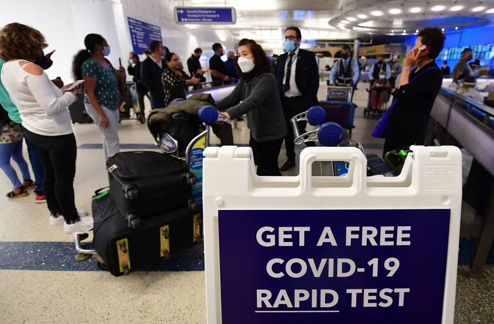 Travelers arrive in the international terminal at Los Angeles International Airport on December 3, 2021, where a rapid Covid-19 testing site opened. 