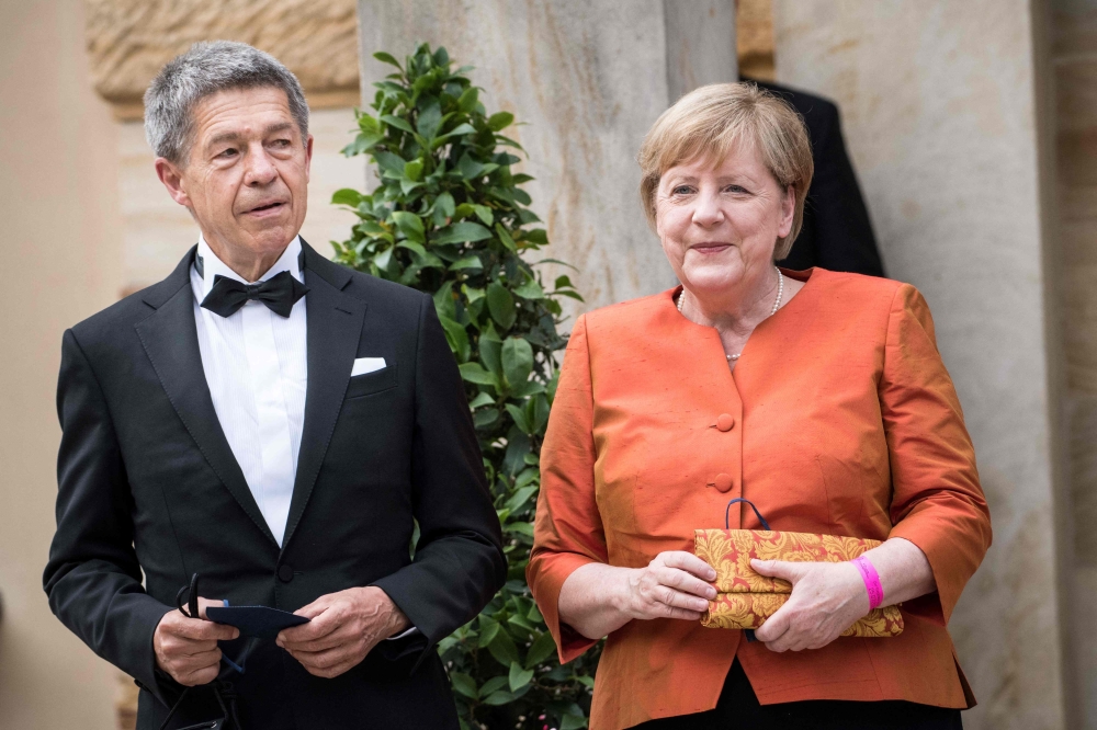 German Chancellor Angela Merkel and her husband Joachim Sauer arrive for the opening ceremony of the annual Bayreuth Festival 