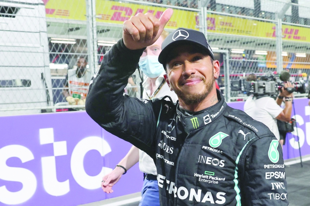 Mercedes' driver Lewis Hamilton celebrates in the parc ferme after taking pole position in the qualifying session of the Saudi Arabian Grand Prix. -- AFP