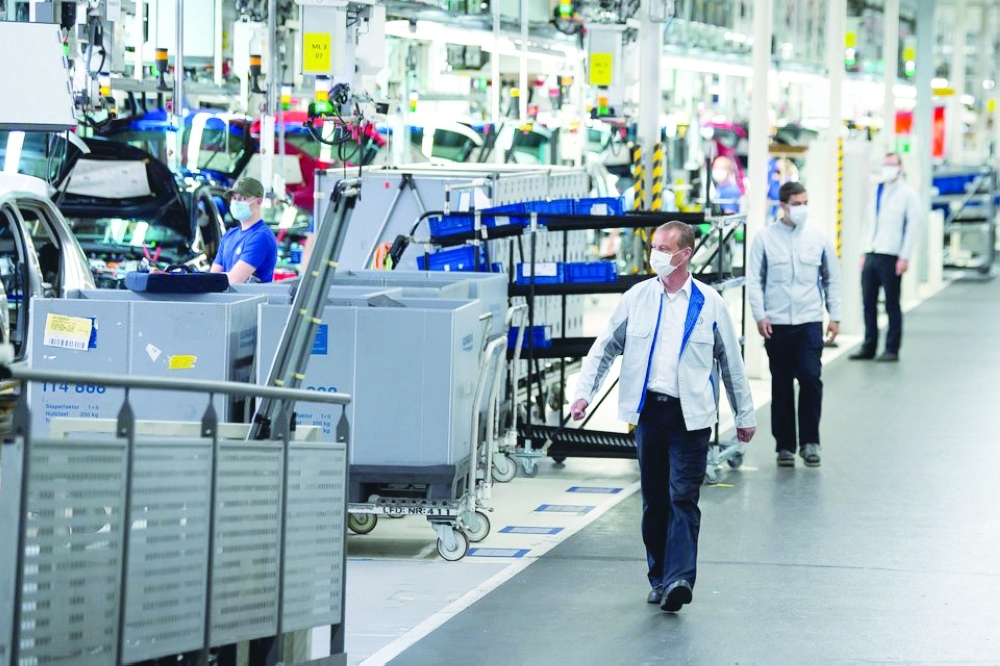 Staff wear protective masks at the Volkswagen assembly line in Wolfsburg, Germany. — Reuters