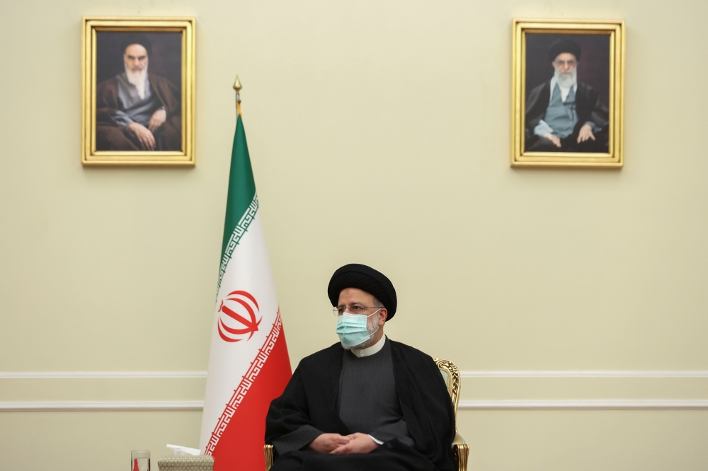 Iran's President Ebrahim Raisi looks on during a meeting with Syria's Foreign Minister Faisal Mekdad in Tehran, Iran, December 6, 2021. 