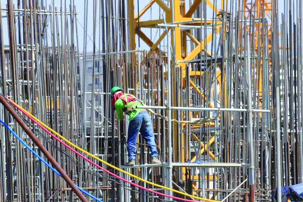  A worker installs steel rods at a construction site in Paranaque city, Metro Manila, Philippines. — Reuters