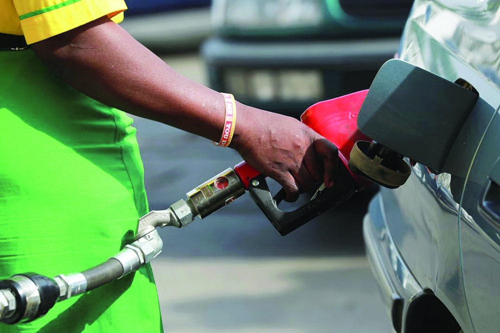 A gas station attendant pumps fuel into a car in Abuja, Nigeria. — Reuters
