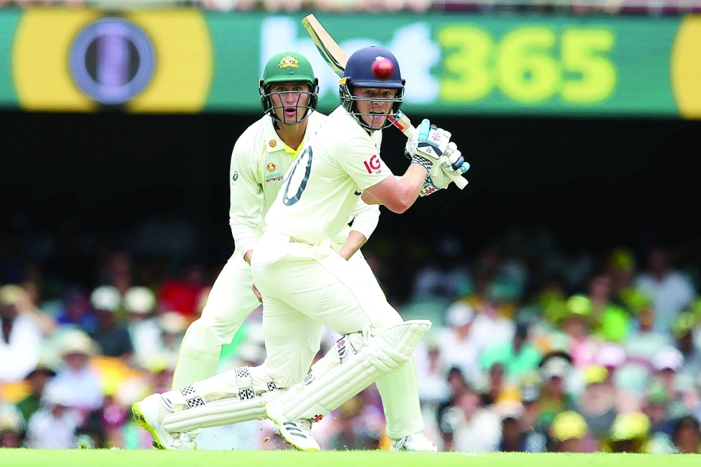 Cricket - Ashes - First Test - Australia v England - The Gabba, Brisbane, Australia - December 8, 2021 England's Ollie Pope plays a shot during day one of the First Ashes Test Jono Searle/AAP Image via REUTERS  ATTENTION EDITORS - THIS IMAGE WAS PROVIDED BY A THIRD PARTY. NO RESALES. NO ARCHIVES. AUSTRALIA OUT. NEW ZEALAND OUT
