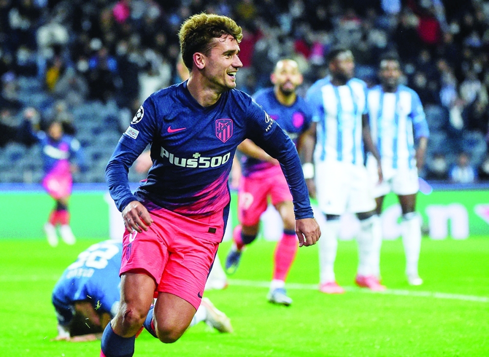 TOPSHOT - Atletico Madrid's French forward Antoine Griezmann celebrates after scoring his team's first goal during the UEFA Champions League first round group B football match between FC Porto and Club Atletico de Madrid at the Dragao stadium in Porto on December 7, 2021. (Photo by MIGUEL RIOPA / AFP)


