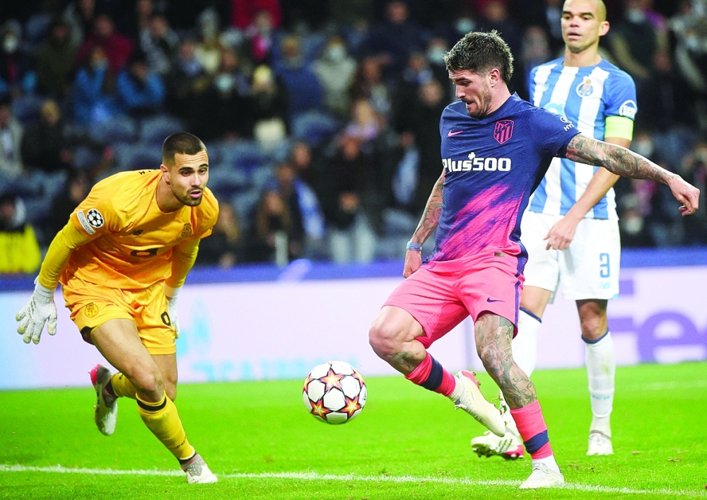 Atletico Madrid's Argentinian midfielder Rodrigo De Paul (C) shoots and scores his team's third goal during the UEFA Champions League first round group B football match between FC Porto and Club Atletico de Madrid at the Dragao stadium in Porto on December 7, 2021. (Photo by MIGUEL RIOPA / AFP)

