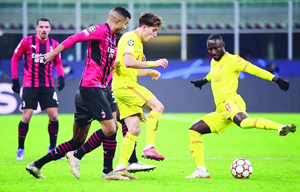 Soccer Football - Champions League - Group B - AC Milan v Liverpool - San Siro, Milan, Italy - December 7, 2021  Liverpool's Naby Keita and Kostas Tsimikas in action with AC Milan's Junior Messias REUTERS/Alberto Lingria
