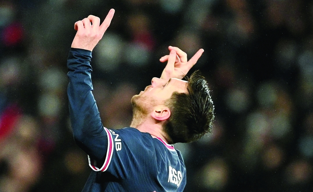 Paris Saint-Germain's Argentinian forward Lionel Messi celebrates after scoring a second goal during the UEFA Champions League first round day 6 Group A football match between Paris Saint-Germain (PSG) and Club Brugge, at the Parc des Princes stadium in Paris on December 7, 2021.  (Photo by Anne-Christine POUJOULAT / AFP)

