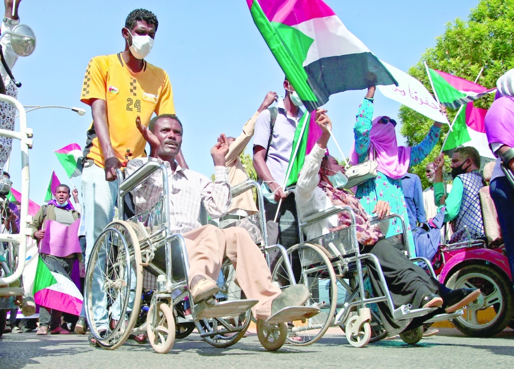 Sudanese demonstrators including persons with disabilities rally along the central Mek Nimr avenue in the capital Khartoum to protest a deal that saw the Prime Minister reinstated after his ouster in a military coup in October. - AFP


