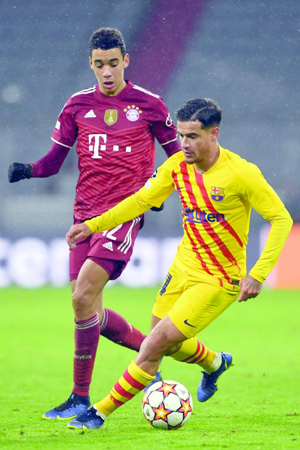 Barcelona's Philippe Coutinho (R) and Jamal Musiala vie for the ball during the UEFA Champions League group E match. -- AFP