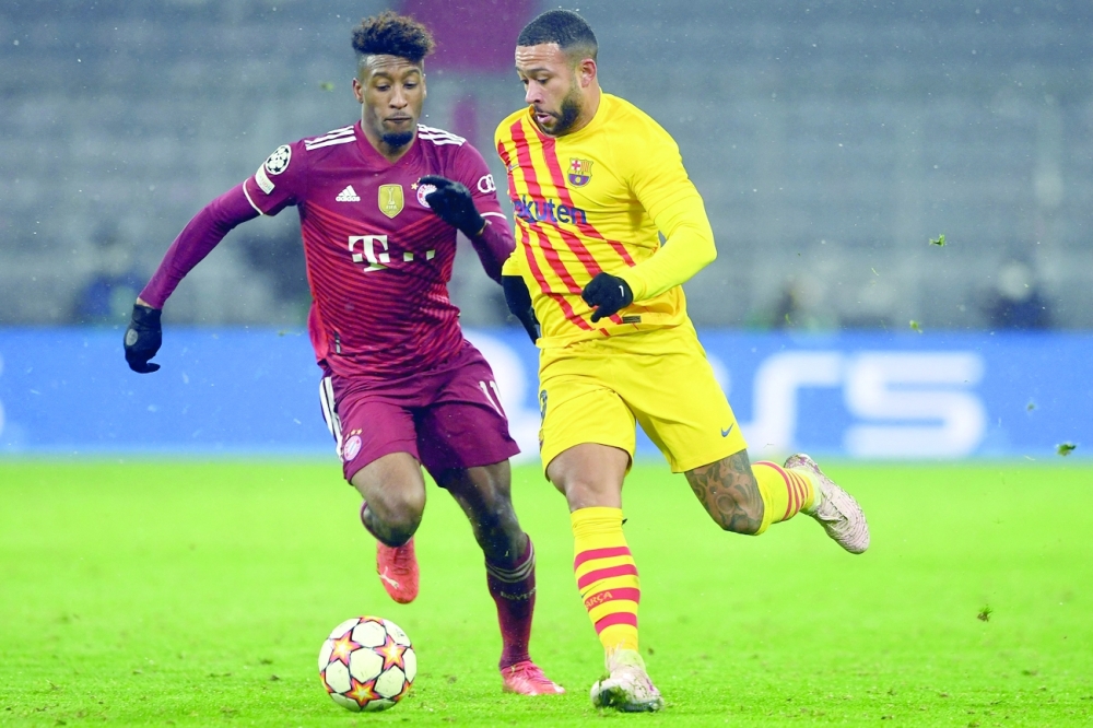 Barcelona's Memphis Depay (R) and Bayern Munich's Kingsley Coman vie for the ball. -- AFP