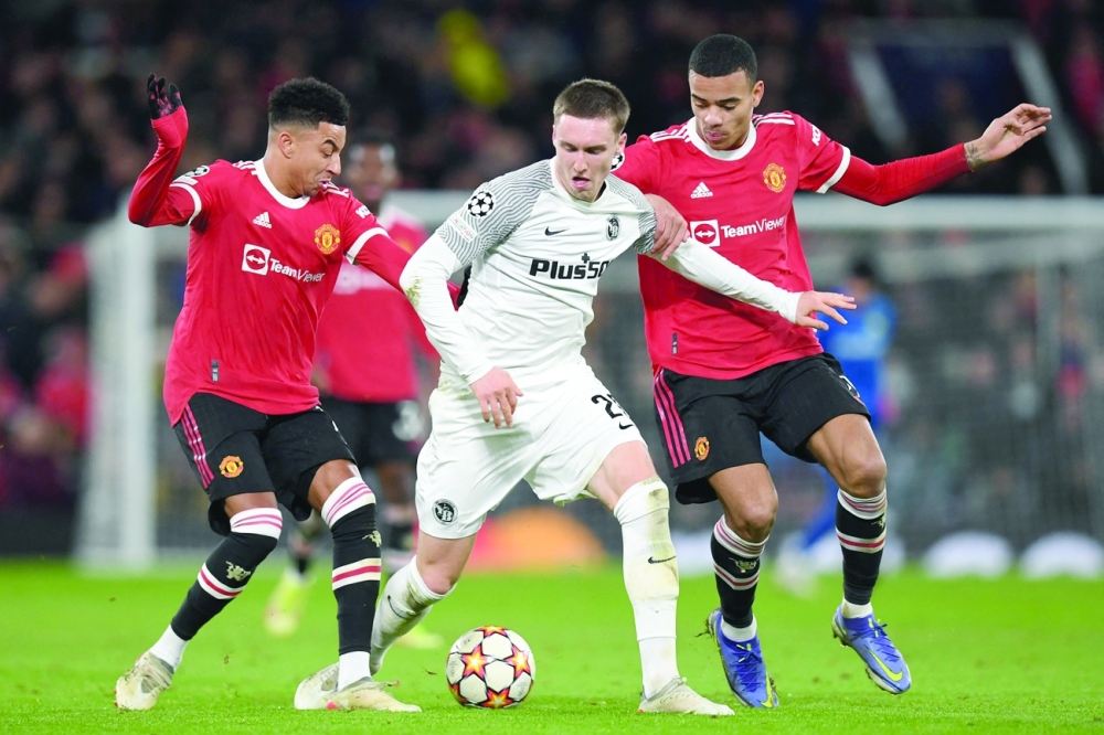 Young Boys' midfielder Michel Aebischer (C) vies with Manchester United's English midfielder Jesse Lingard (L) and Mason Greenwood. -- AFP