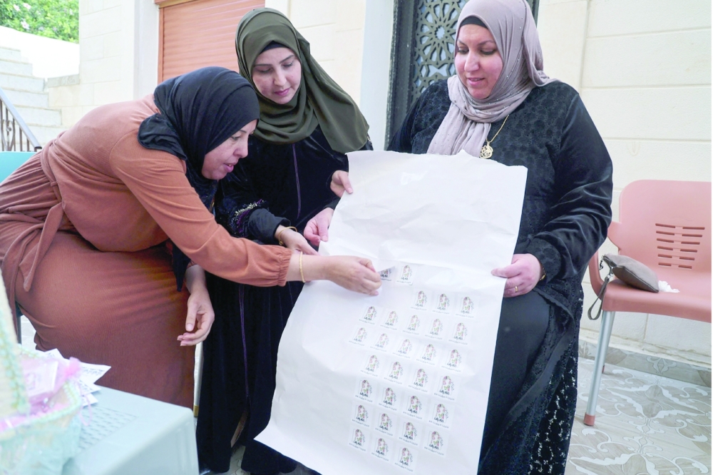 Palestinian female candidates for local council elections prepare campaign merchandise in their village of Burqin on December 2. - AFP