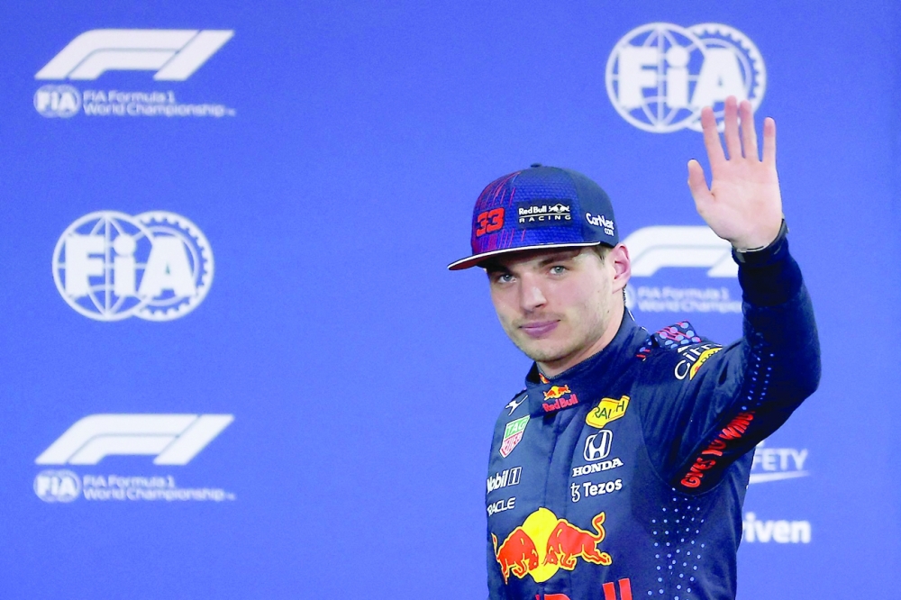 Red Bull's Dutch driver Max Verstappen waves in the Parc Ferme of the Yas Marina Circuit. -- AFP