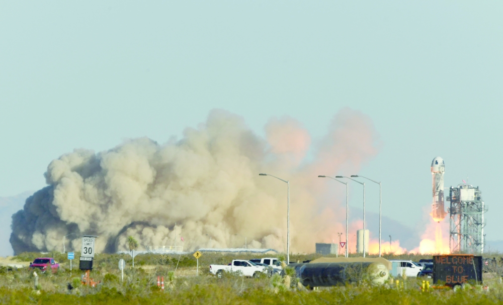 A Blue Origin New Shepard rocket launches on December 11, 2021, in West Texas near Van Horn.  The NS-19 mission will take Laura Shepard Churchley (inset), Television talk show host Michael Strahan, Dylan Taylor, Evan Dick, Lane Bess and Cameron Bess into  space. — AFP