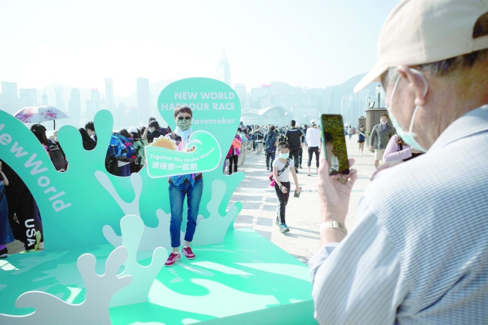 An onlooker poses for a photo during the annual harbour swimming race in Hong Kong. -- AFP