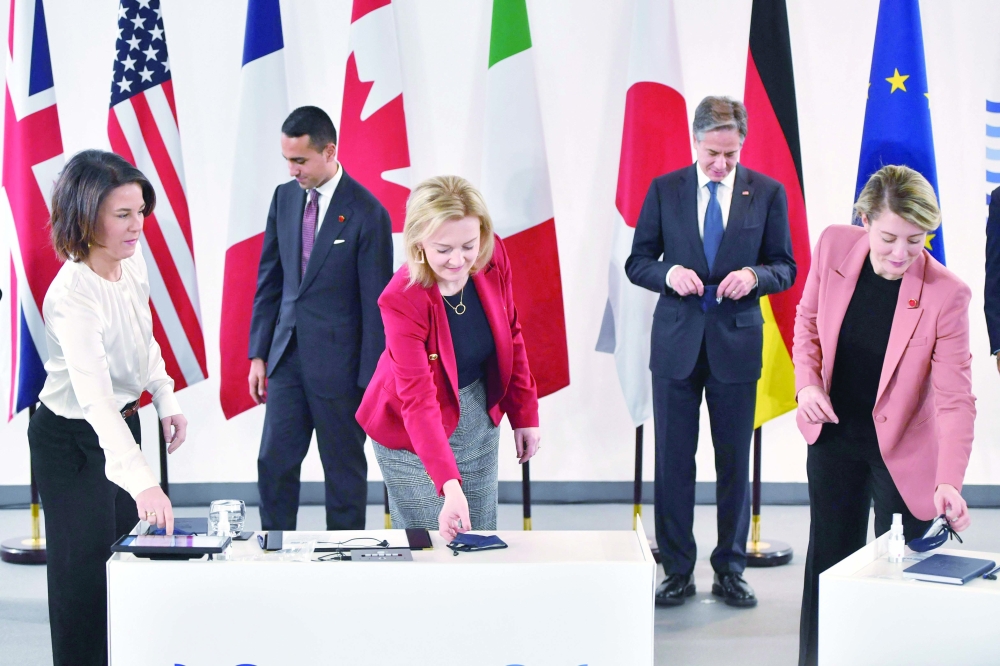 Germany's Foreign Minister Annalena Baerbock, Italy's Foreign Minister Luigi Di Maio, Britain's Foreign Secretary Liz Truss, US Secretary of State Antony Blinken and Canada's Minister of Foreign Affairs Melanie Joly remove their face coverings after posing for a family photograph during the G7 summit of foreign and development ministers. - AFP

