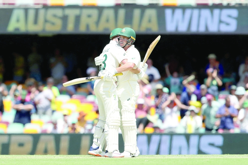 Marnus Labuschagne and Marcus Harris of Australia celebrate winning the first Test. -- Reuters