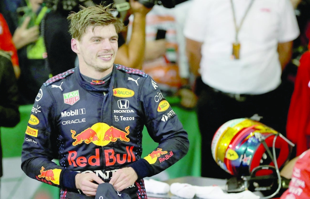 Red Bull's driver Max Verstappen celebrates in the parc ferme of the Yas Marina Circuit after the Abu Dhabi Grand Prix. -- AFP