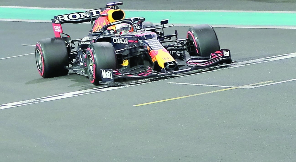 Red Bull's Max Verstappen crosses the finish line at the Yas Marina Circuit during the Abu Dhabi Grand Prix. -- AFP