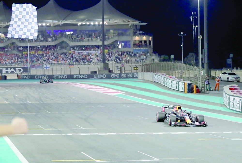 Red Bull's driver Max Verstappen crosses the finish line at the Yas Marina Circuit during the Abu Dhabi Grand Prix. -- AFP
