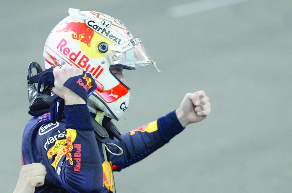 Red Bull's Max Verstappen celebrates winning the race and the world championship. -- Reuters