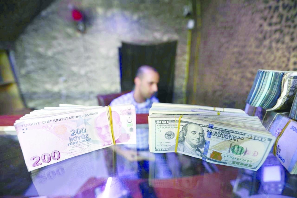 Banknotes of US dollars and Turkish lira are seen in a currency exchange shop in Istanbul.  — Reuters