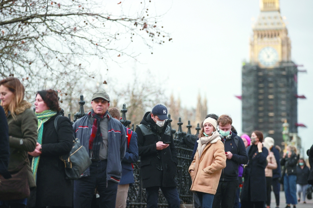 People queue outside a Covid-19 vaccination centre at St Thomas’s Hospital in London, on Monday. — Reuters