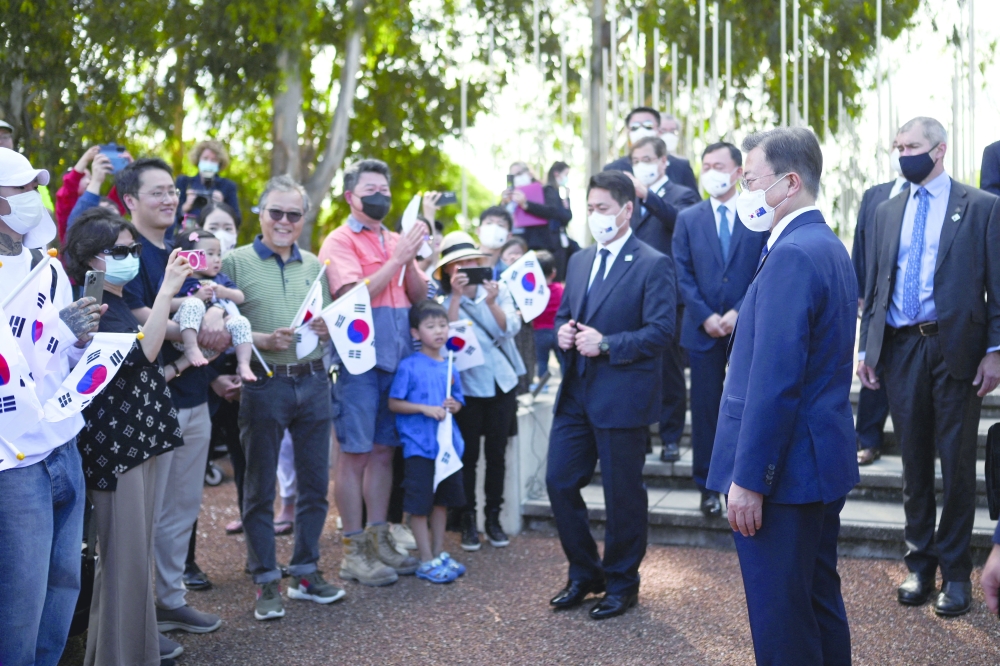 South Korean President Moon Jae-in greets members of the public after laying a wreath at the Australian National Korean War Memorial in Canberra. — Reuters