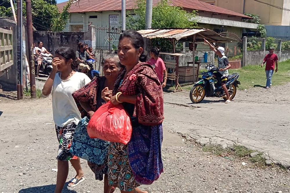 Women are seen evacuating, as a 7.4-magnitude earthquake struck eastern Indonesia triggering a tsunami warning in Maumere, East Nusa Tenggara, Indonesia, on Tuesday. - Reuters 