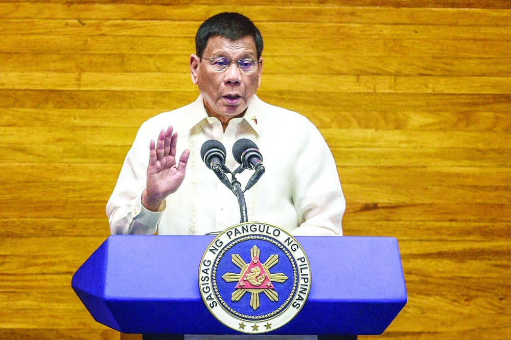 (FILES) This file photo taken on July 26, 2021 shows Philippine President Rodrigo Duterte speaking during the annual state of the nation address at the House of Representatives in Manila. Duterte on December 14, 2021 withdrew his candidacy for the 2022 Senate race, the government elections monitor said, a month after making a last-minute entry into the elections contest. (Photo by JAM STA ROSA / POOL / AFP)
