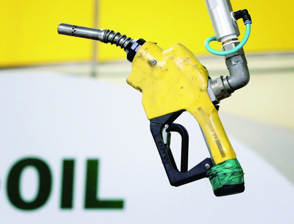 A gas pump is seen hanging from the ceiling at a petrol station in Seoul, South Korea. — Reuters