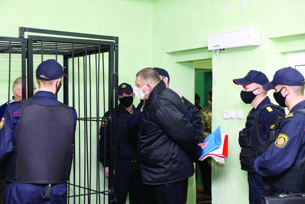 Sergei Tikhanovsky is escorted before the verdict hearing in his trial on charges of organising riots and inciting social hatred, at a detention centre in the southeastern city of Gomel on Tuesday. - AFP