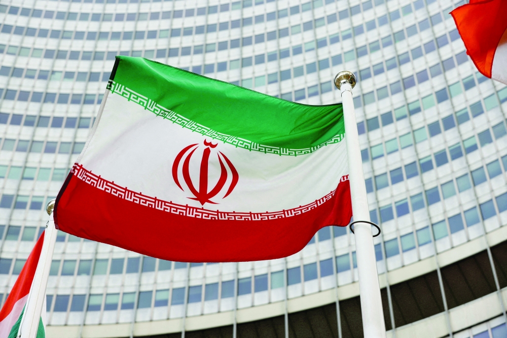 FILE PHOTO: The Iranian flag waves in front of the International Atomic Energy Agency (IAEA) headquarters in Vienna, Austria May 23, 2021. REUTERS/Leonhard Foeger//File Photo