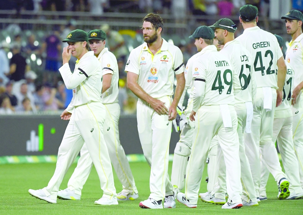 Australia's Michael Neser with teammates as lightning stops play. --  Reuters