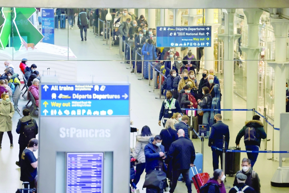 Passengers queue to board Eurostar trains at St Pancras International station in London on Friday, the final day before new restrictions are imposed on travellers to combat the spread of the Omicron variant. - AFP 