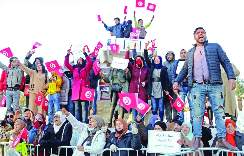 Unemployed Tunisian graduates chant slogans during a demonstration to mark the 10th anniversary of the start of the 2011 revolution, on Friday, in Sidi Bouzid, stronghold of the Tunisian revolution. - AFP