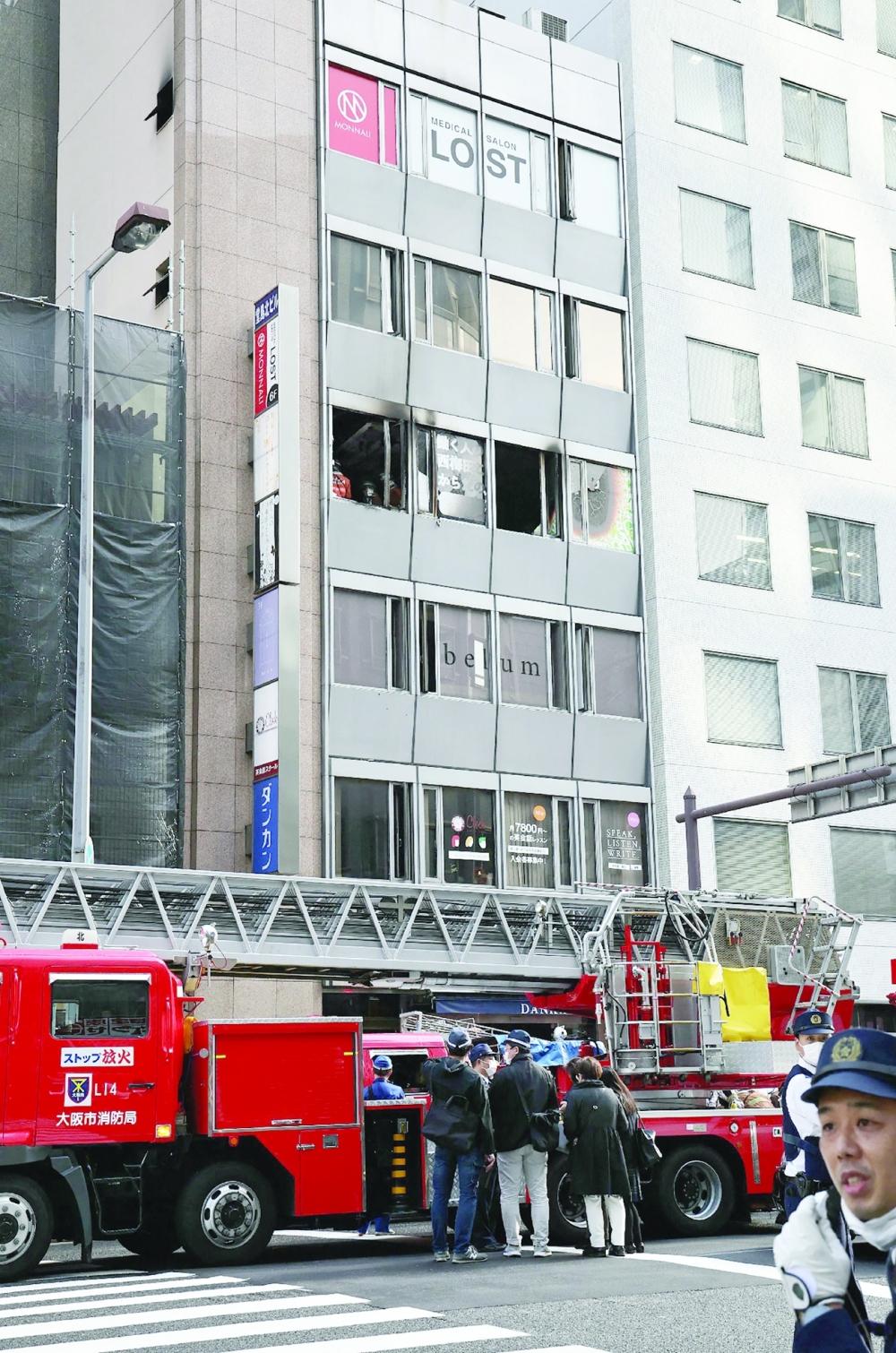 Firefighters work at the scene, where 27 people were feared dead after a blaze at a building in Osaka, on Friday. - AFP
