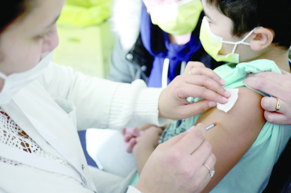 A medical worker administers a dose of a coronavirus vaccine to a child at a vaccination centre in Les Pavillons-sous-Bois, near Paris on Saturday. — Reuters
