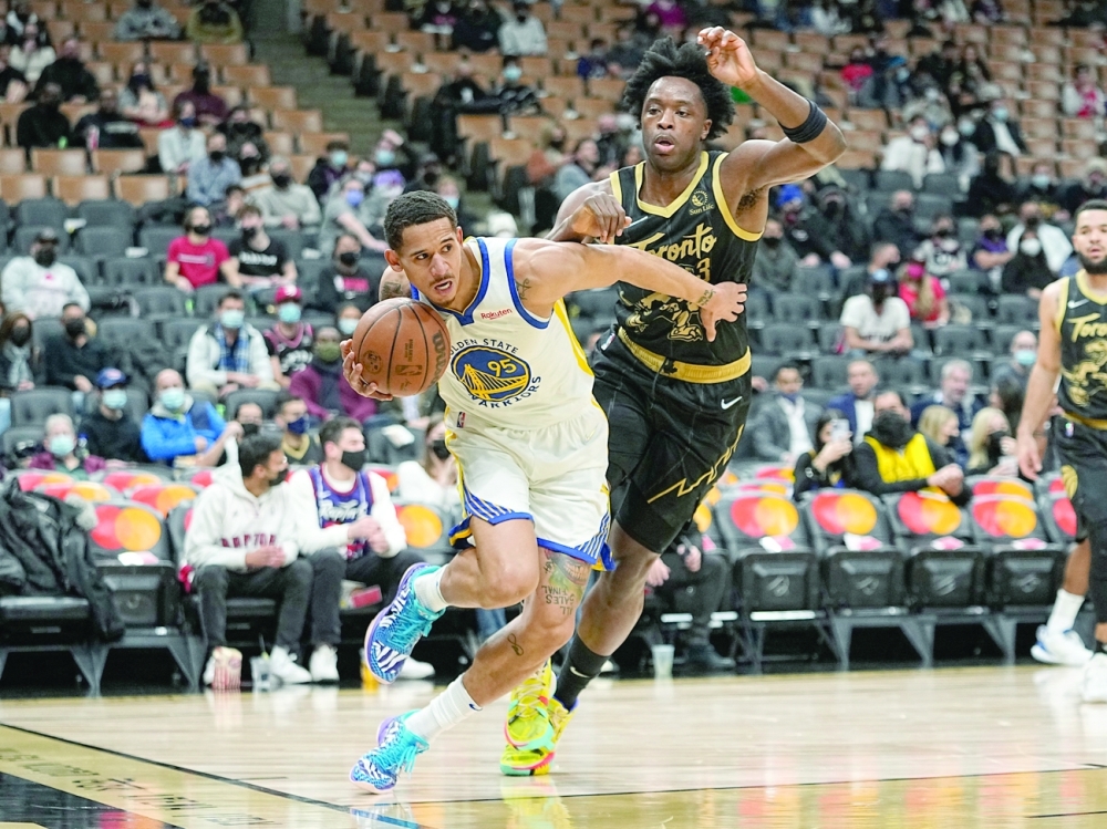 Golden State Warriors' Juan Toscano-Anderson (95) drives against Toronto Raptors' OG Anunoby (3) during the first half at Scotiabank Arena. -- USA Today Sports
