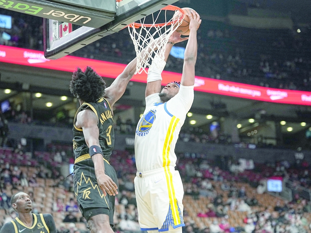 Golden State Warriors' Kevon Looney (5) dunks against Toronto Raptors forward OG Anunoby (3) during the first half at Scotiabank Arena. -- USA Today Sports
