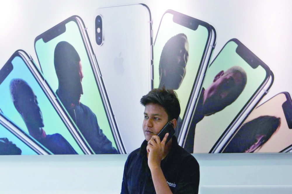 A salesperson speaks on the phone at an Apple reseller store in Mumbai. — Reuters