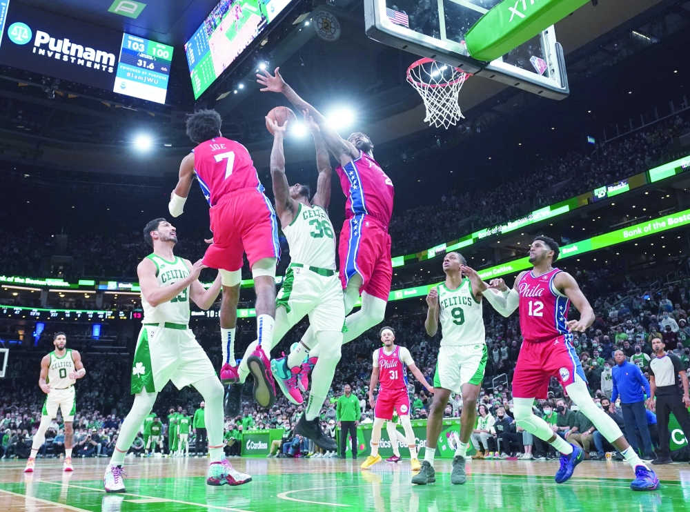 Dec 20, 2021; Boston, Massachusetts, USA; Philadelphia 76ers center Joel Embiid (21) defends against Boston Celtics guard Marcus Smart (36) in the second half at TD Garden. Mandatory Credit: David Butler II-USA TODAY Sports