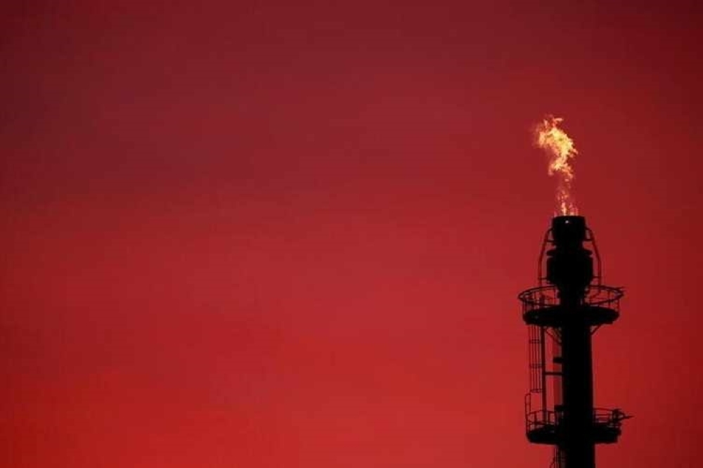 Flames come out of a chimney at the French oil giant Total Refinery in Donges, France. — Reuters